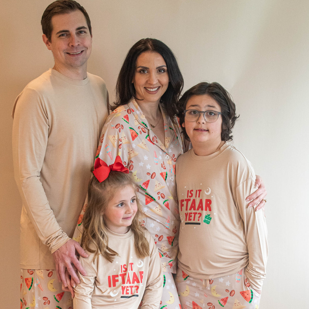 dad, mom and two children wearing pajamas