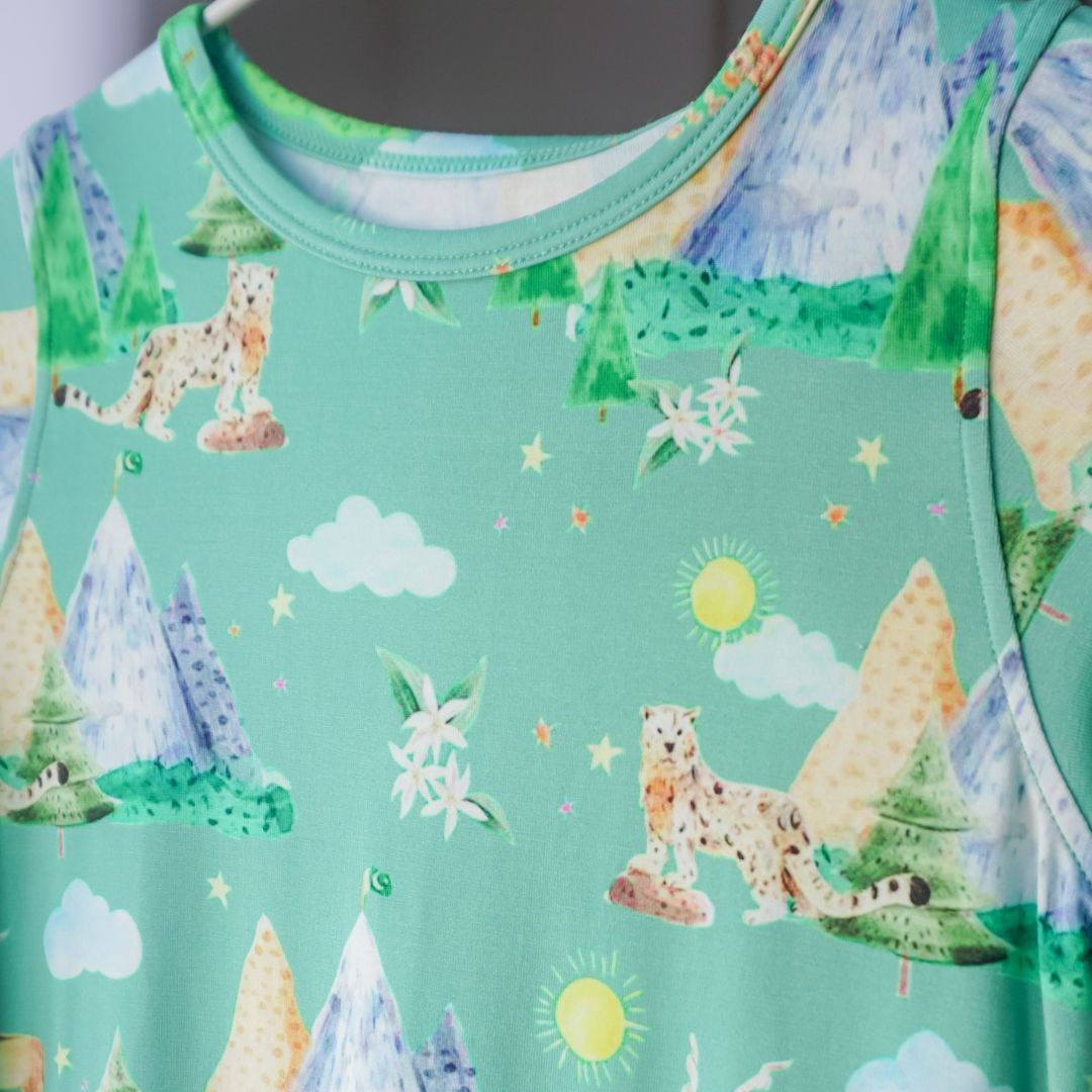 close up of pajama print.  snow leapards, mountains, clouds, jasmine flowers.