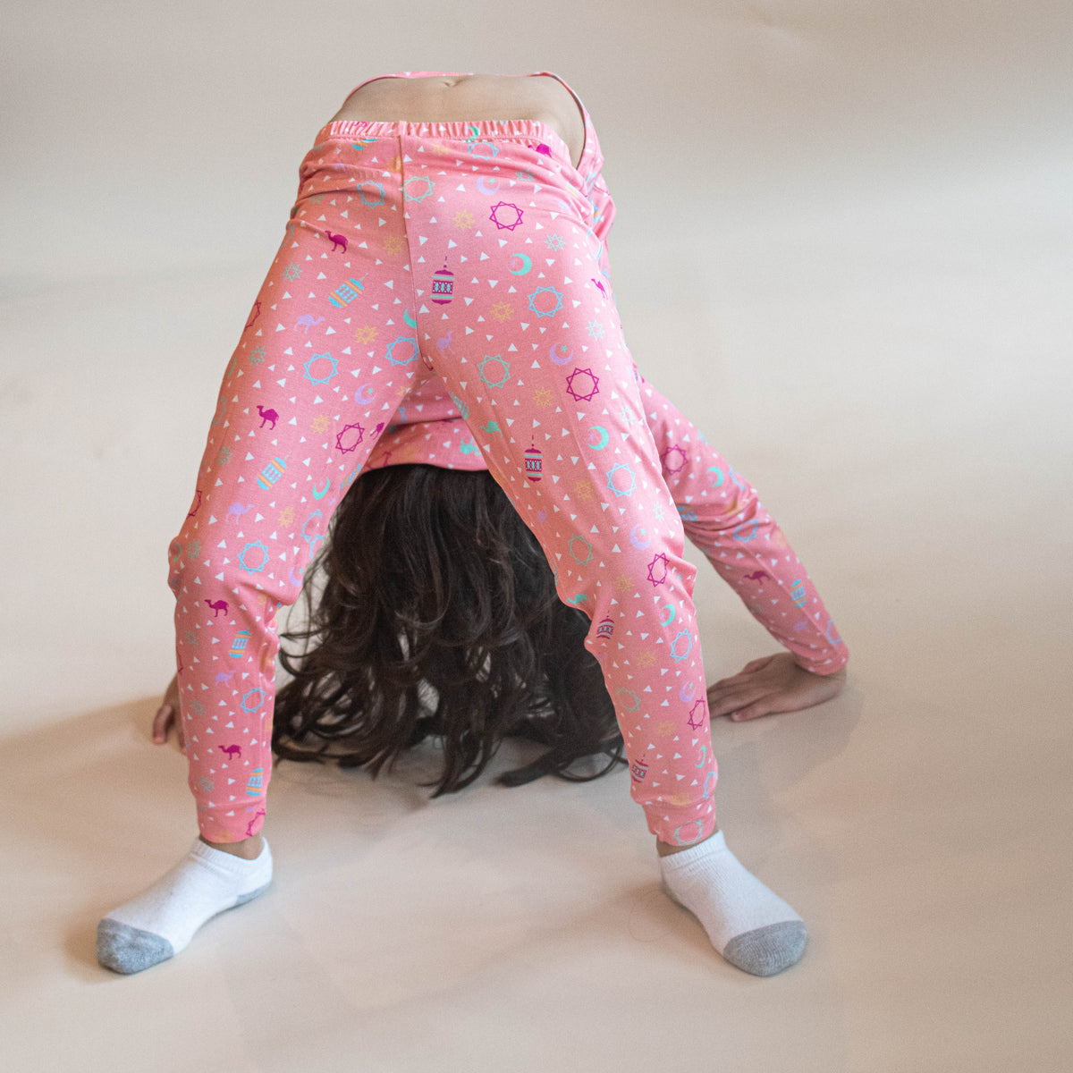 girl doing back bend wearing pink pjs
